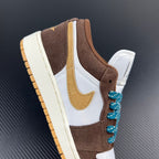 Low-top sneakers, brown and white with teal laces and gold swoosh on side.