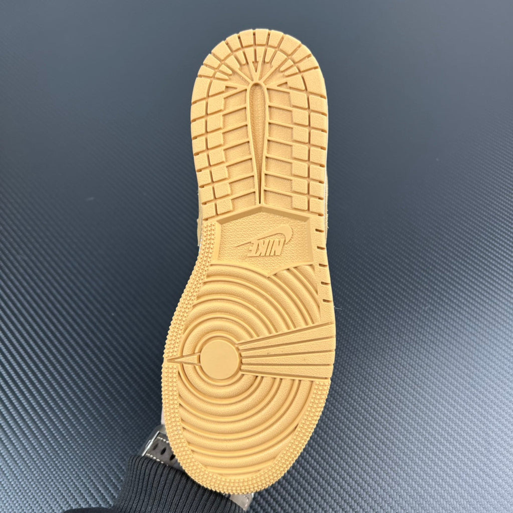 Shoe outsole, light tan rubber tread with circular pattern and logo.