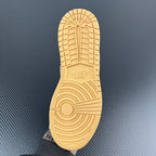 Shoe outsole, light tan rubber tread with circular pattern and logo.