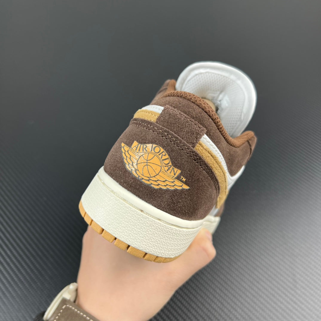 Low-top sneakers heel view in brown suede with Jumpman logo and cream sole.