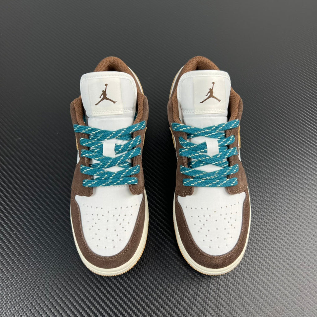 Pair of low-top sneakers, brown and white with teal laces and rear Jumpman branding.