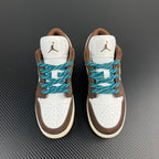 Pair of low-top sneakers, brown and white with teal laces and rear Jumpman branding.