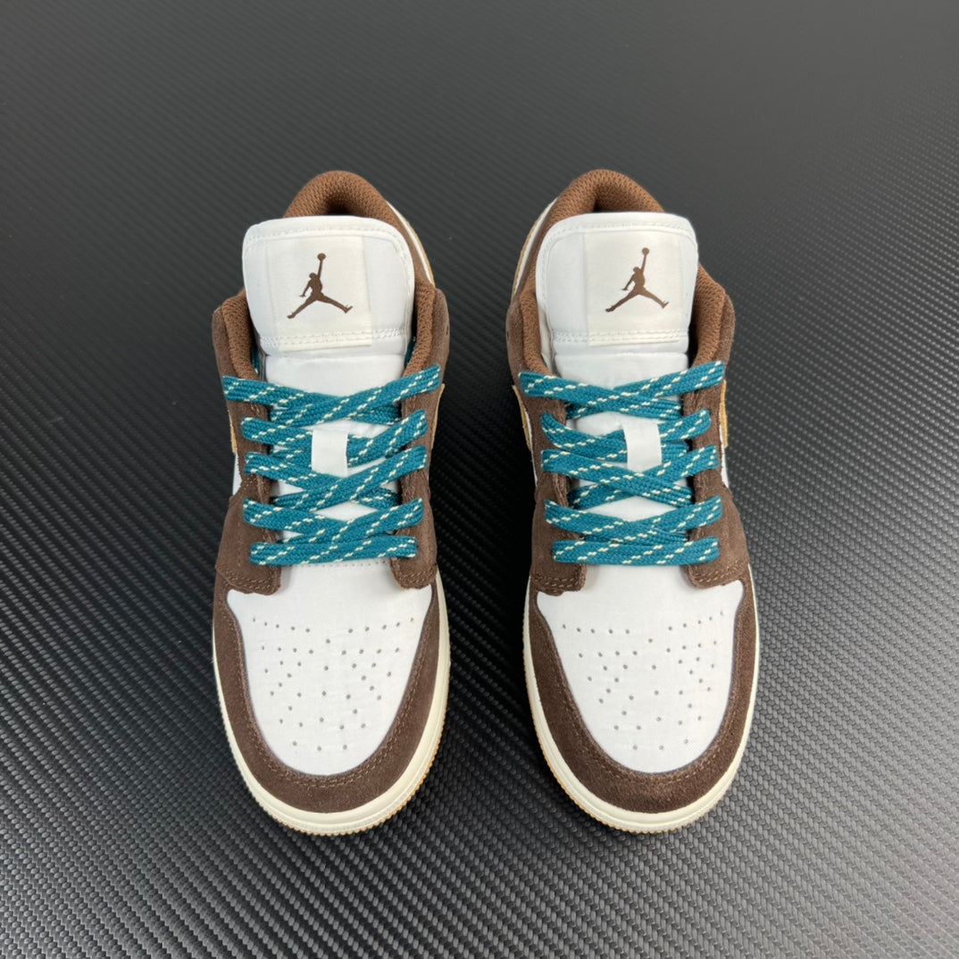 Pair of low-top sneakers, brown and white with teal laces and rear Jumpman branding.