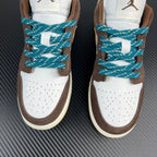 Front view low-top sneakers with white toe, brown sides, teal lace crisscross.