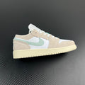 Air Jordan 1 Low sneakers with white, tan and mint swoosh, lace-up.