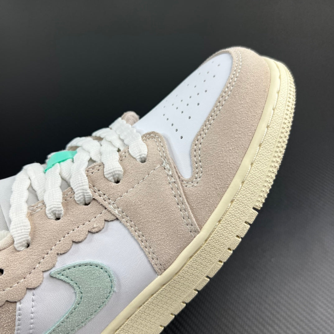 Air Jordan 1 Low toe and laces with mint swoosh detail, beige overlays.