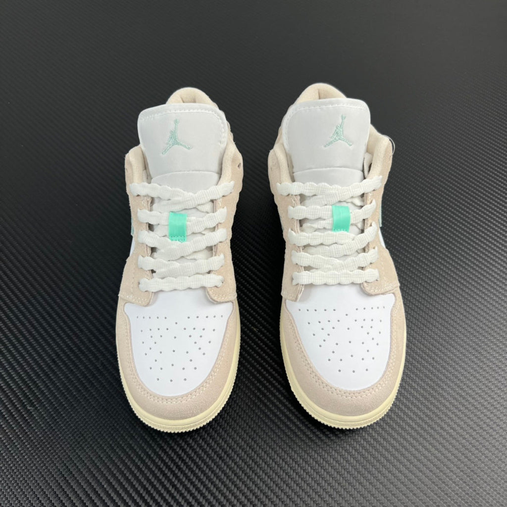 Air Jordan 1 Low pair, white uppers with tan heel panels and mint Air logo.