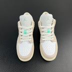 Air Jordan 1 Low pair, white uppers with tan heel panels and mint Air logo.