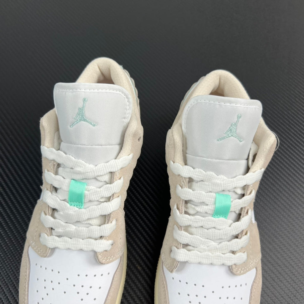 Air Jordan 1 Low pair heel view, mint Air logos on white collars and laces.