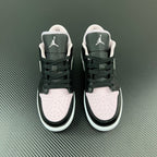 Air Jordan 1 Low sneakers pair, black uppers with white toe panels and Air logo