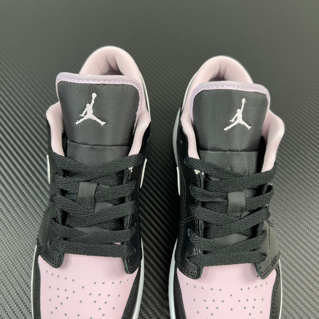 Air Jordan 1 Low sneakers pair, black laces with pink collar and white toe panels