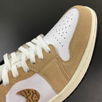 Tan and white low-top sneaker with perforated toe, lace-up, and side panel