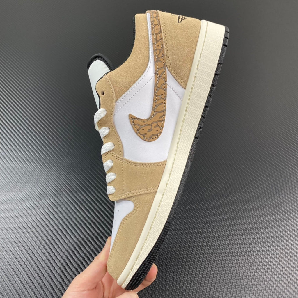 Tan and white Air Jordan low-top sneaker, side view with lace-up and sail sole