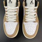 Pair of tan and white low-top sneakers with perforated toe and white laces