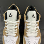 Pair of tan and white low-top sneakers with AIR logo on tongues and laces