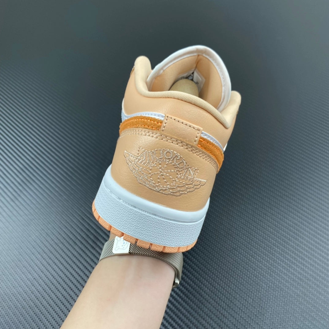 Air Jordan 1 Low sneakers heel view with tan lining and embossed logo detail