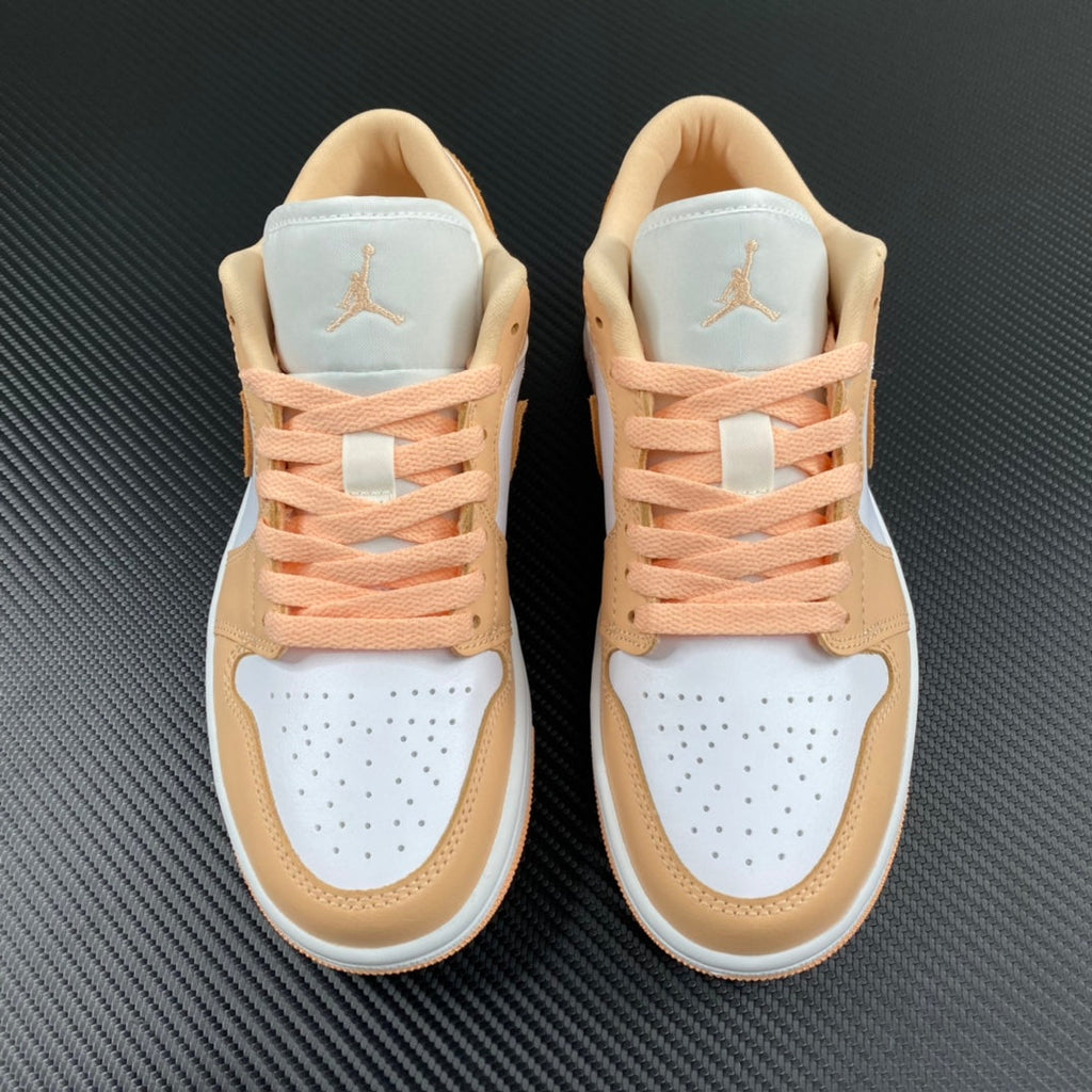 Air Jordan 1 Low sneakers pair view with peach laces and tan-and-white uppers