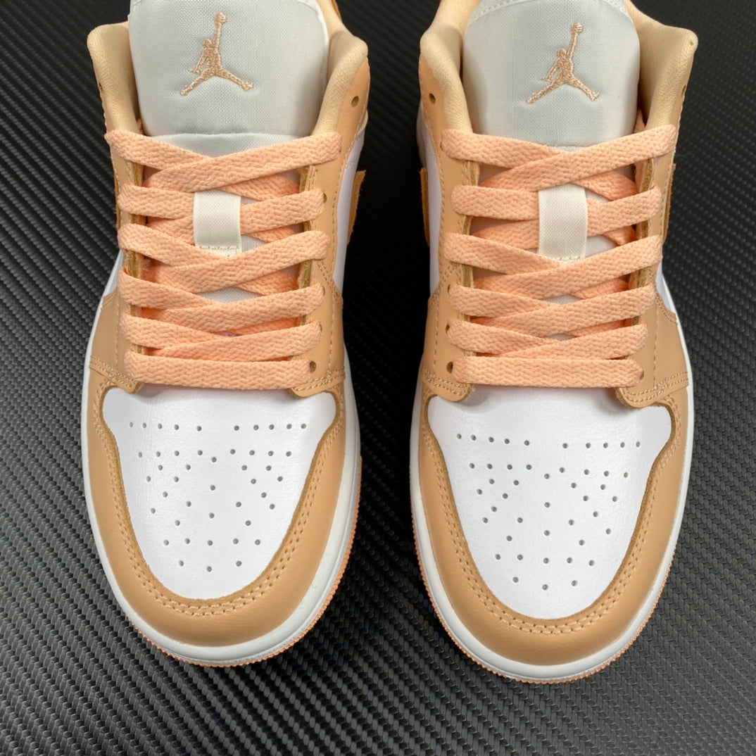 Air Jordan 1 Low sneakers rear view with peach laces, white toe caps, tan overlays