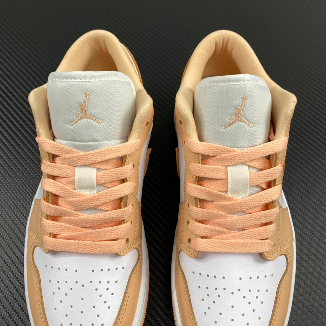 Air Jordan 1 Low sneakers front view with peach laces and white perforated toe