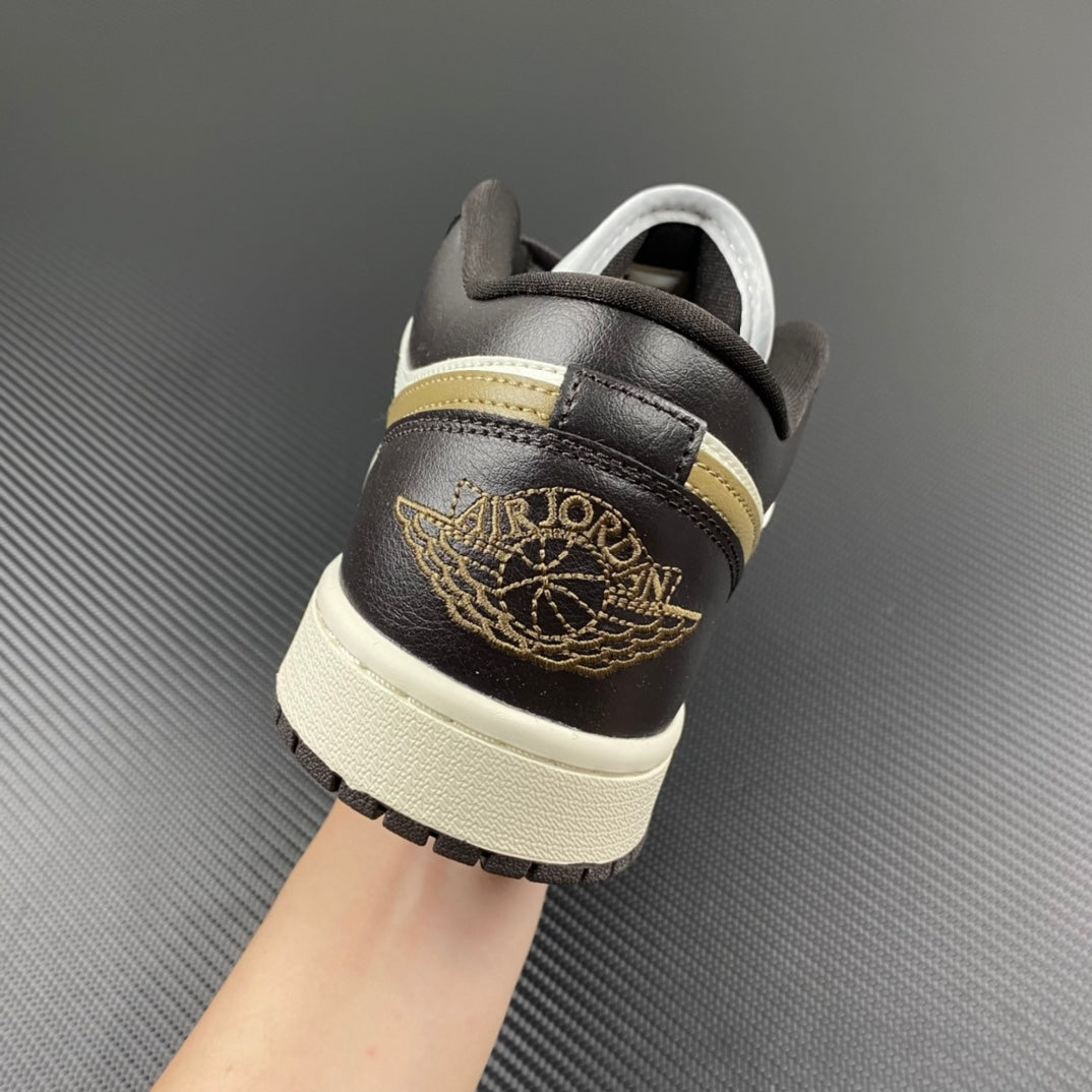 Heel of low-top sneakers in dark brown leather with gold winged emblem