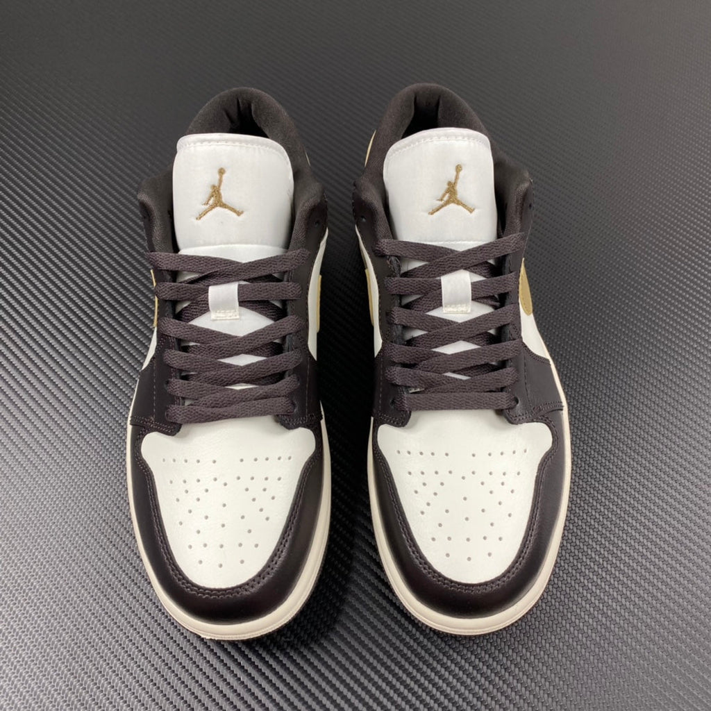 Pair of low-top sneakers with white tongues, dark brown laces, and Air Jordan logos