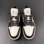 Pair of low-top sneakers with white tongues, dark brown laces, and Air Jordan logos