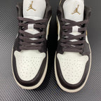Pair of low-top sneakers with white toe boxes, dark brown uppers, and gold logos