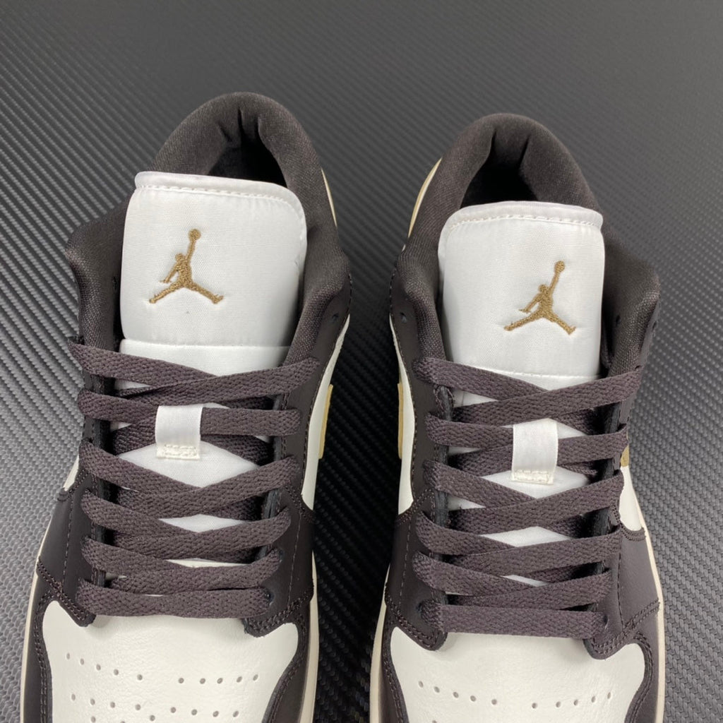 Back view of low-top sneakers with white heel panels and Air Jordan gold logos