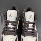Back view of low-top sneakers with white heel panels and Air Jordan gold logos