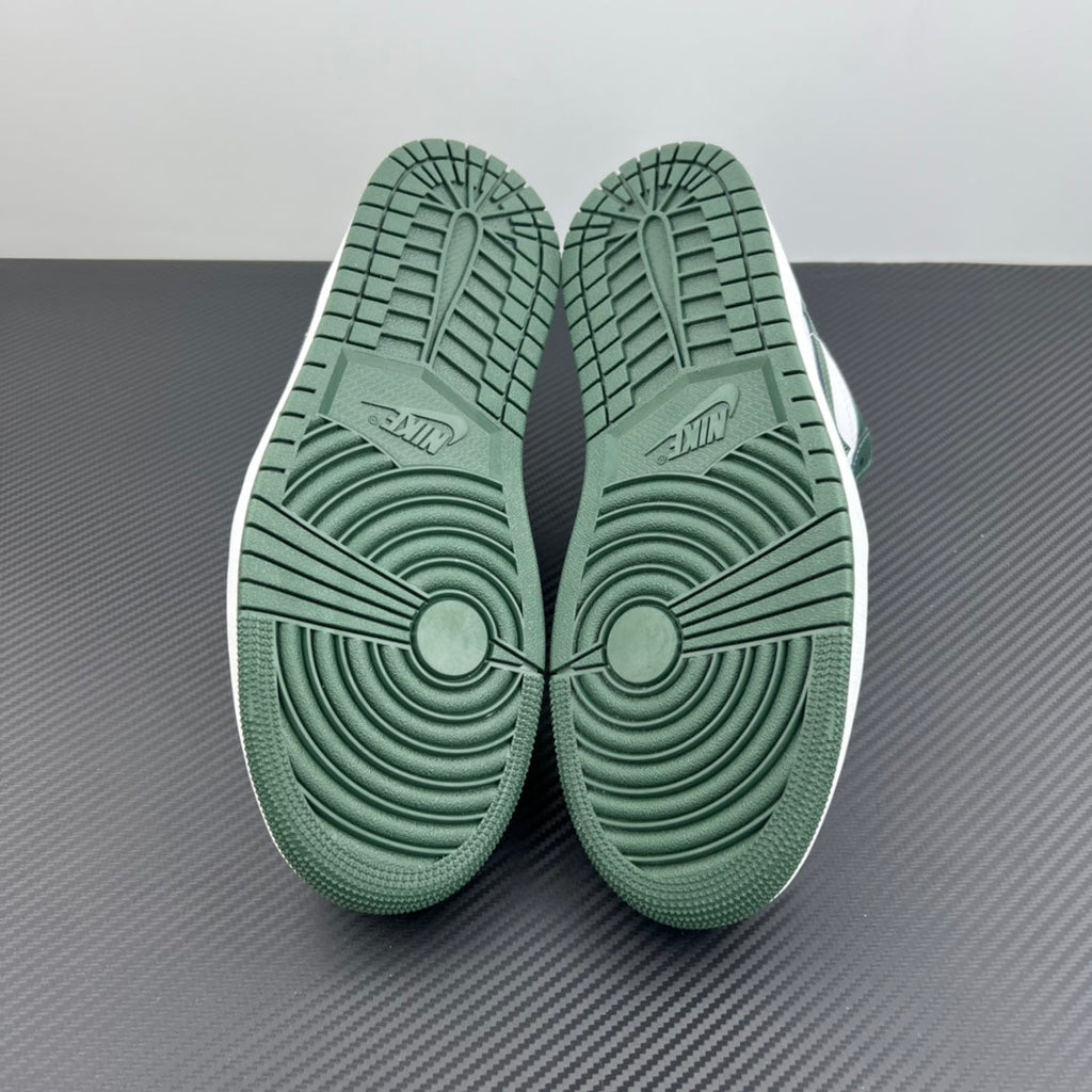 Low-top sneakers bottom view with dark green rubber outsole traction pattern