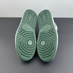 Low-top sneakers bottom view with dark green rubber outsole traction pattern