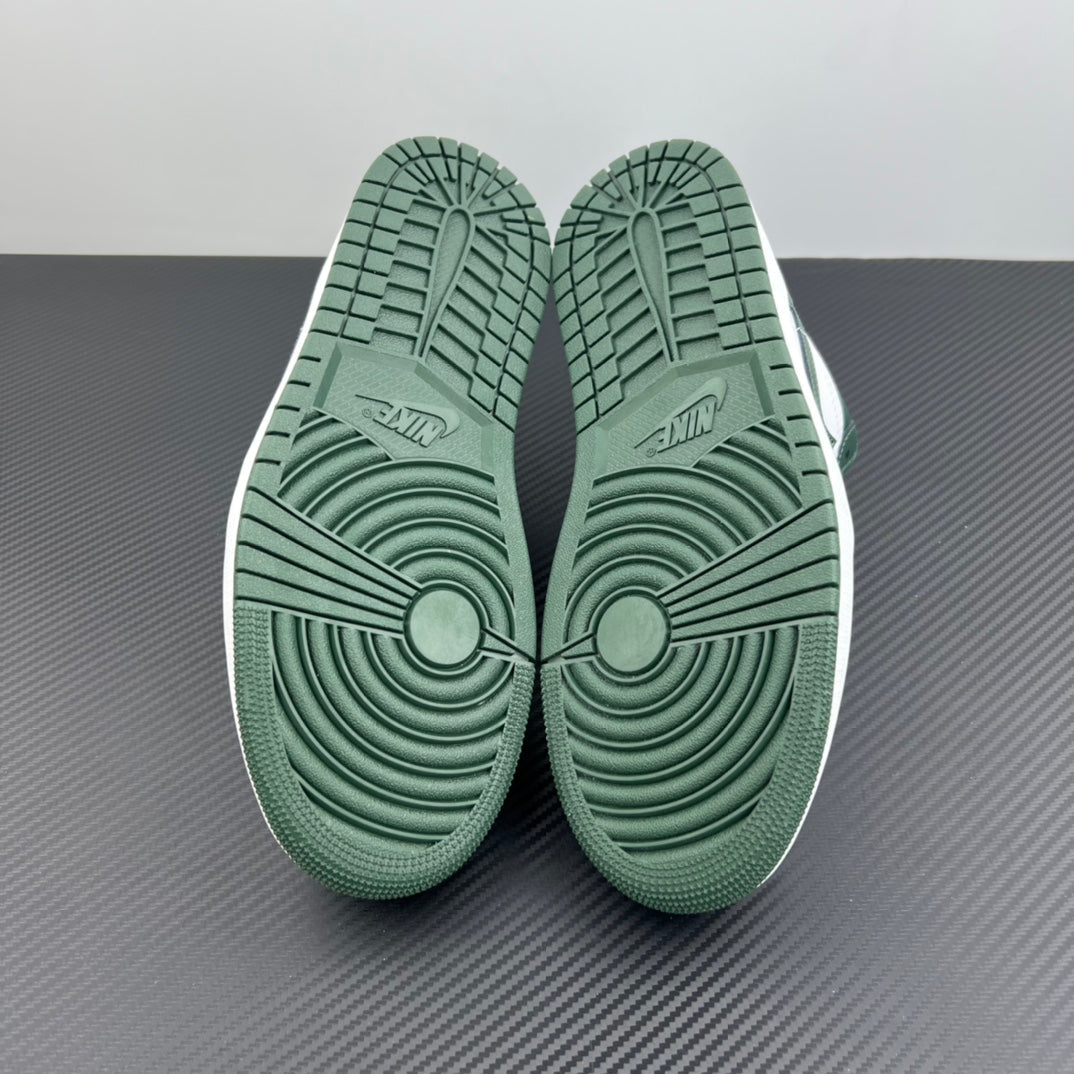 Low-top sneakers bottom view with dark green rubber outsole traction pattern