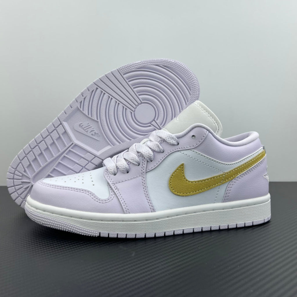 Women’s Air Jordan 1 Low sneakers with visible outsole tread, light lavender upper, yellow swoosh