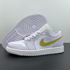 Women’s Air Jordan 1 Low sneakers with visible outsole tread, light lavender upper, yellow swoosh