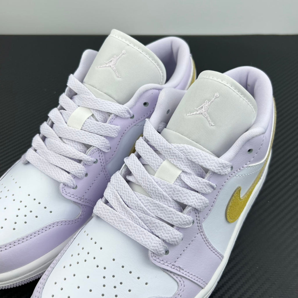 Women’s Air Jordan 1 Low sneakers pair, light lavender uppers with yellow swoosh and white laces