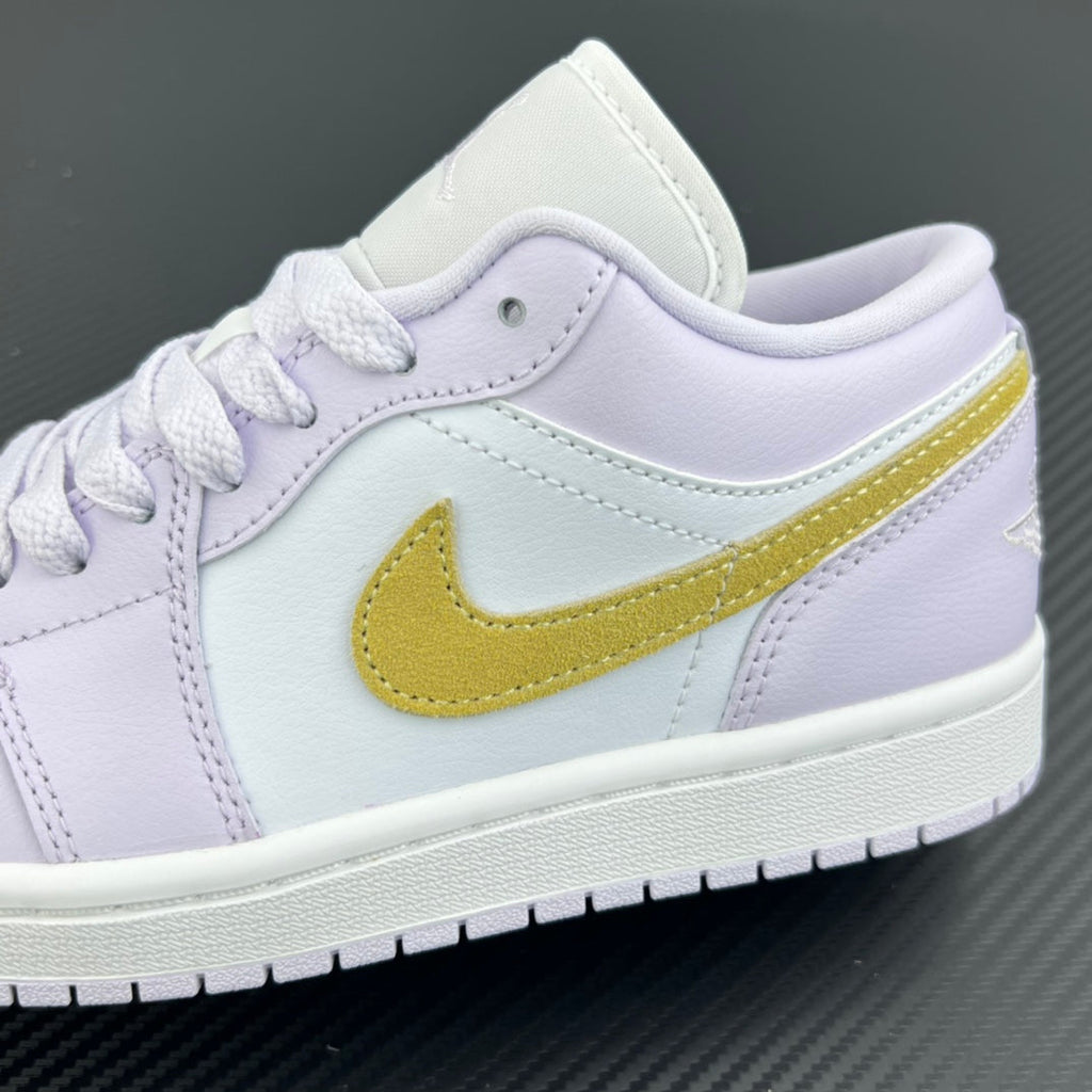 Women’s Air Jordan 1 Low sneaker side close-up with yellow swoosh on light lavender leather