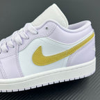Women’s Air Jordan 1 Low sneaker side close-up with yellow swoosh on light lavender leather
