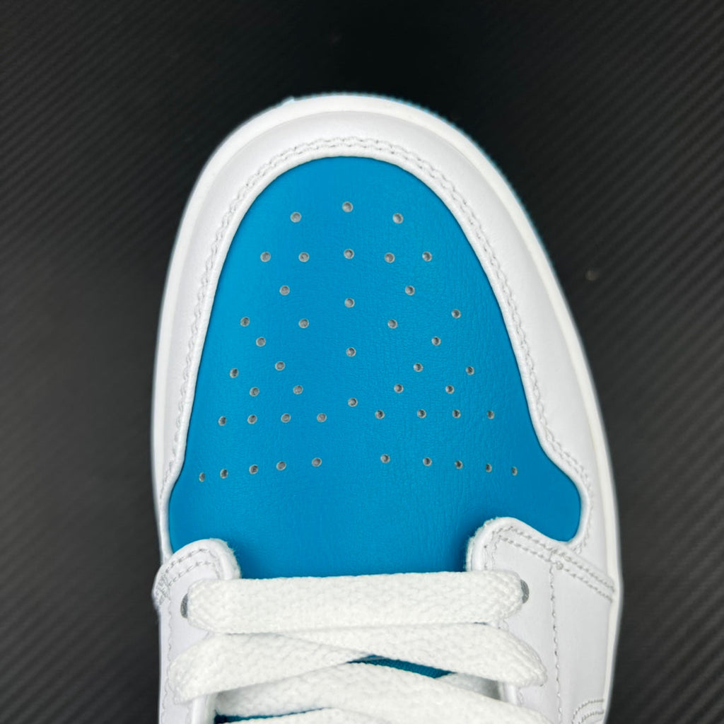 Low-top sneakers toe area close-up, white trim and aqua perforated leather