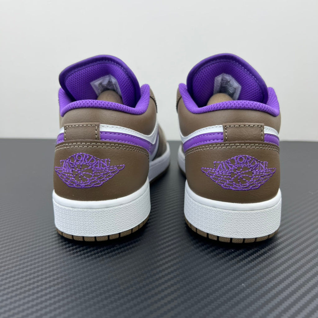 Low-top sneakers with purple collar, brown heel, white midsole, and purple logo