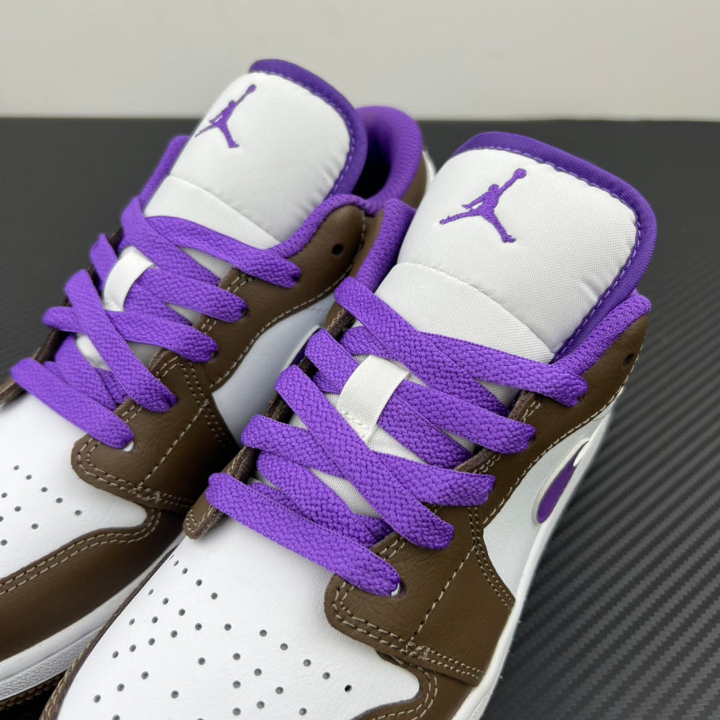 Low-top sneakers with brown quarters, white panels, and purple laces over tongue