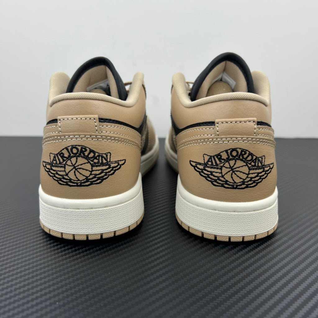 Low-top sneakers heel area, tan leather with navy collar and Air Jordan Wings logo.