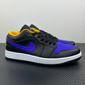 Low-top sneaker with dark upper, purple Swoosh, yellow lining, and white midsole.