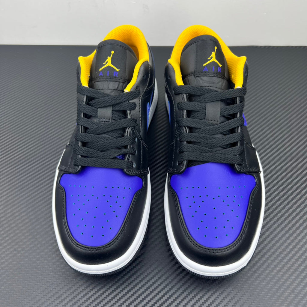 Low-top sneaker pair facing front, dark leather with purple toe, yellow collar lining, white sole.