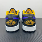 Low-top sneaker heel view with dark leather, yellow collar, winged heel patch, white sole.