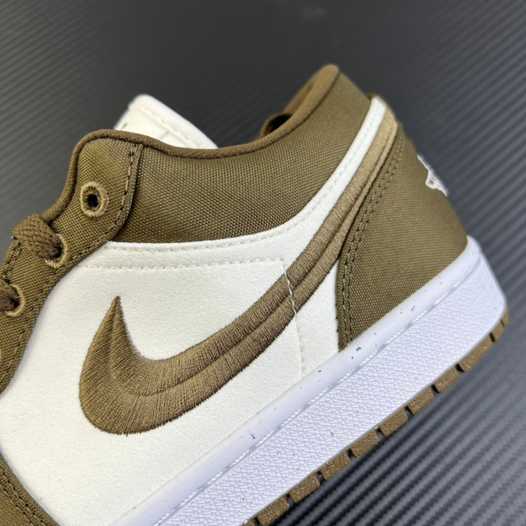Close-up of low-top sneaker side Swoosh in olive on white panel with textured upper