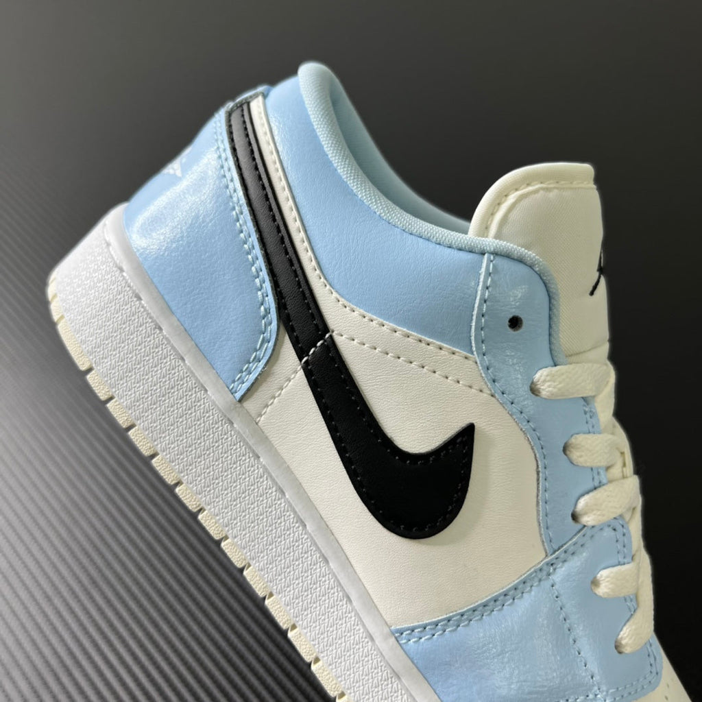 Air Jordan 1 Low sneaker heel and side with black swoosh and ice blue overlays