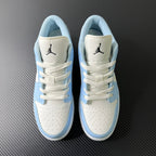 Air Jordan 1 Low pair with white uppers, light blue panels, and Jumpman on tongues