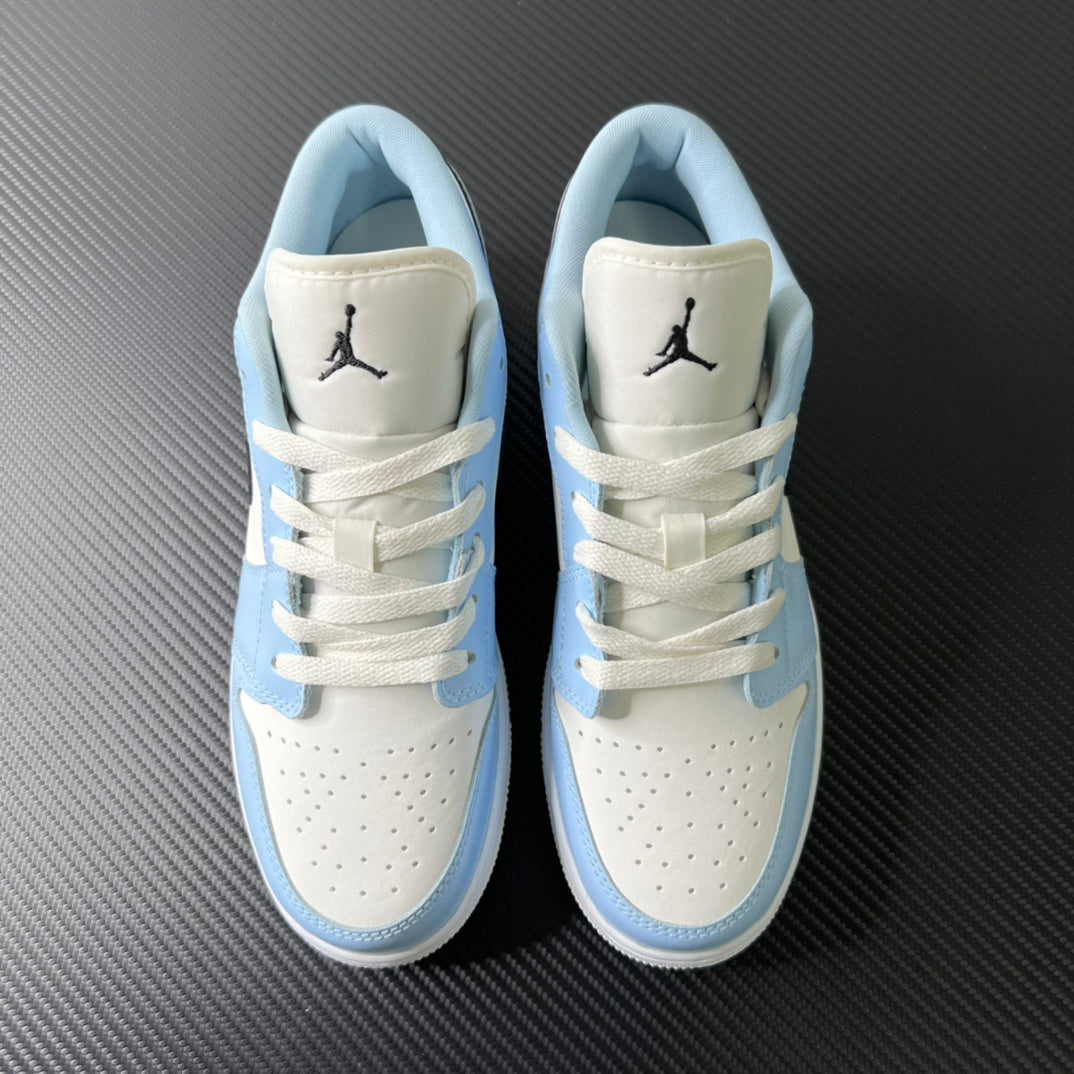 Air Jordan 1 Low pair with white uppers, light blue panels, and Jumpman on tongues