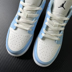 Air Jordan 1 Low front view with perforated toe, ice blue accents, and white laces