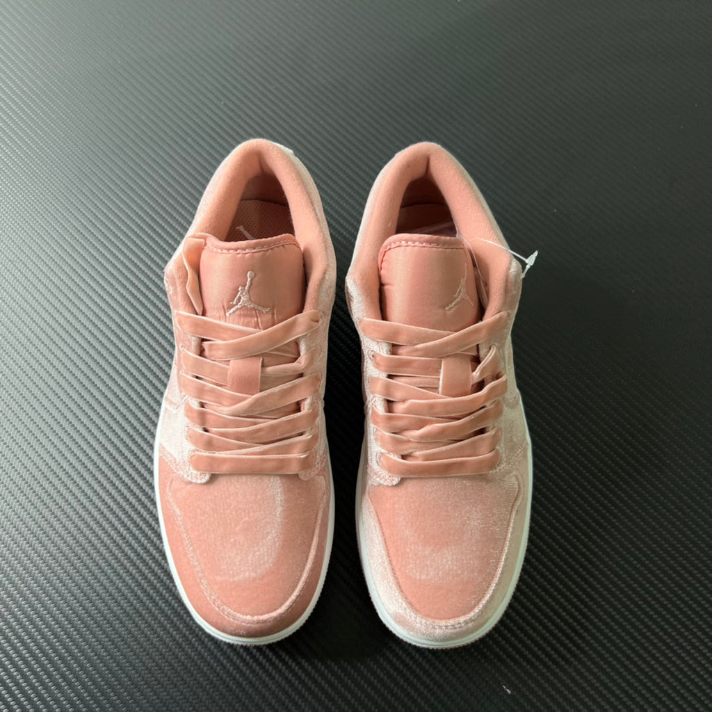 Air Jordan 1 Low pink sneakers pair, laces and padded tongue visible